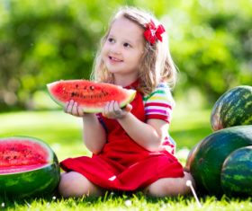 Joyful children are eating a watermelon Stock Photo (4)