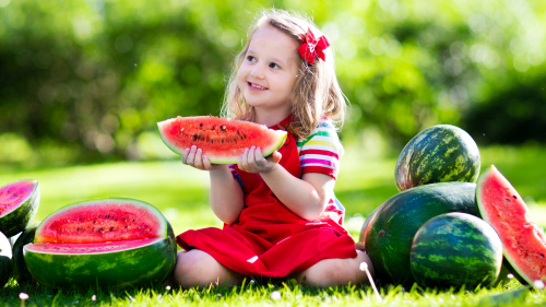 Joyful children are eating a watermelon Stock Photo (4)