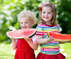 Joyful children are eating a watermelon Stock Photo (5)
