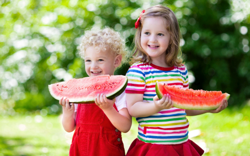 Joyful children are eating a watermelon Stock Photo (5)