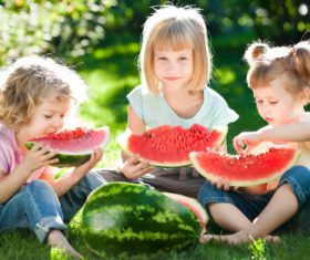Joyful children are eating a watermelon Stock Photo (6)