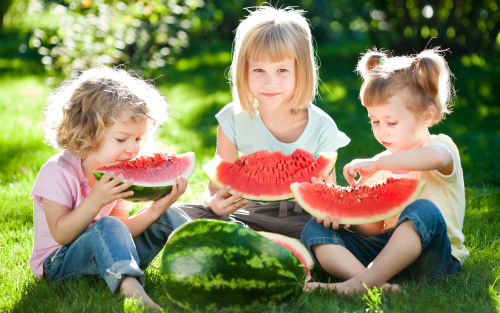 Joyful children are eating a watermelon Stock Photo (6)