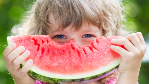 Joyful children are eating a watermelon Stock Photo (7)
