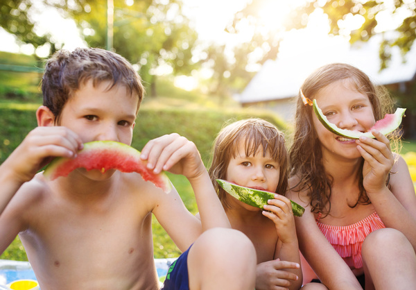 Kids eating watermelon Stock Photo