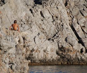 Kids joyful on rocky beach Stock Photo