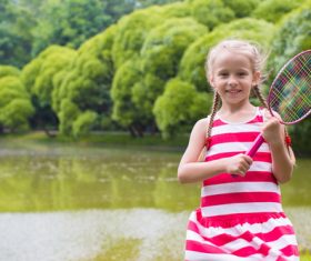 Little girl holds tennis racket Stock Photo