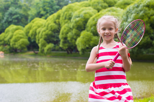 Little girl holds tennis racket Stock Photo