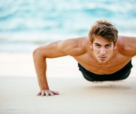 Man exercising on the beach Stock Photo 01