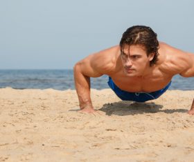Man exercising on the beach Stock Photo 02