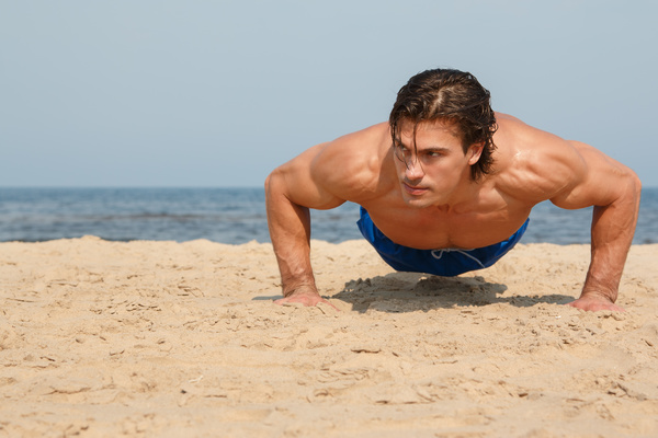Man exercising on the beach Stock Photo 02