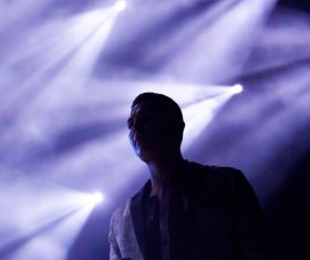 Man posing under violet spotlight Stock Photo