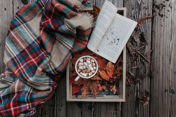 Open book and leaves decoration on wooden table Stock Photo