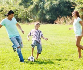 Parents and kids play football Stock Photo