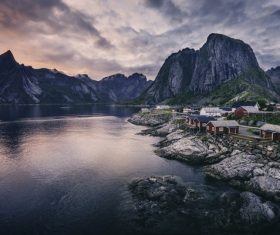 Peaceful village on calm mountain lake area Stock Photo