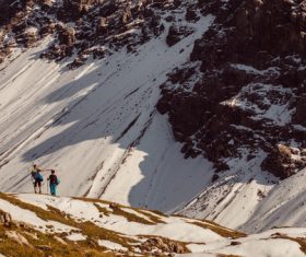 People exploring high snowy rocky mountain Stock Photo