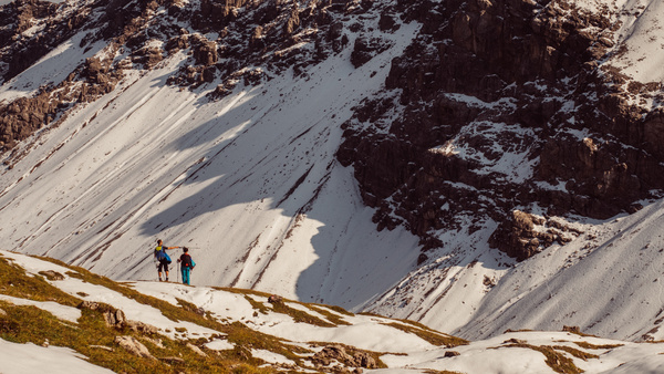 People exploring high snowy rocky mountain Stock Photo