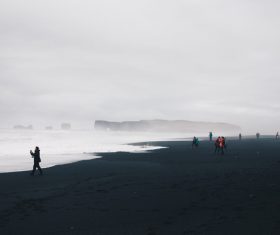 People gathering on wavy cold seaside Stock Photo