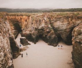 People playing on rocky seaside Stock Photo