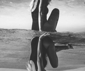 Reflection of attractive bikini woman on water pond Stock Photo