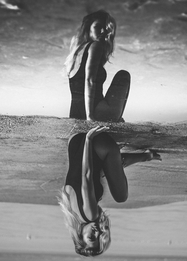 Reflection of attractive bikini woman on water pond Stock Photo
