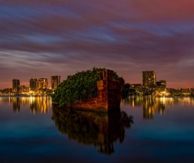 Reflection of beautiful night city on calm lake Stock Photo