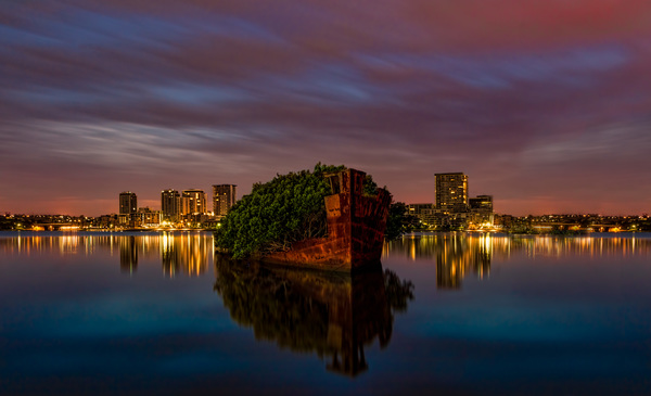Reflection of beautiful night city on calm lake Stock Photo