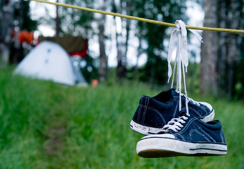 Shoes hanging on rope Stock Photo