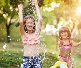 Sisters play in the water of summer Stock Photo 01