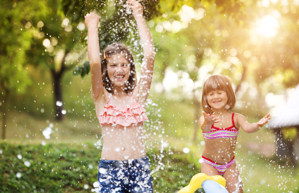 Sisters play in the water of summer Stock Photo 01