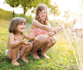 Sisters play in the water of summer Stock Photo 04
