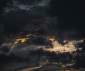 Thick black clouds on dusk sky Stock Photo
