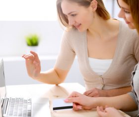 Two girls paying for online shopping Stock Photo 02