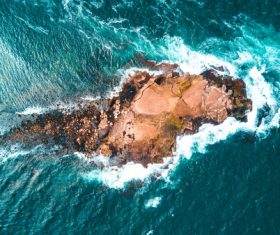 White foam wavy on rocky beach Stock Photo