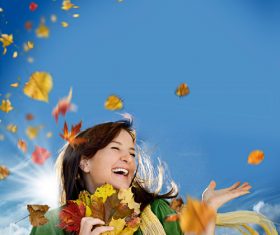 Woman collecting autumn leaves happy Stock Photo