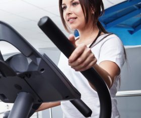 Woman doing exercise on treadmill Stock Photo