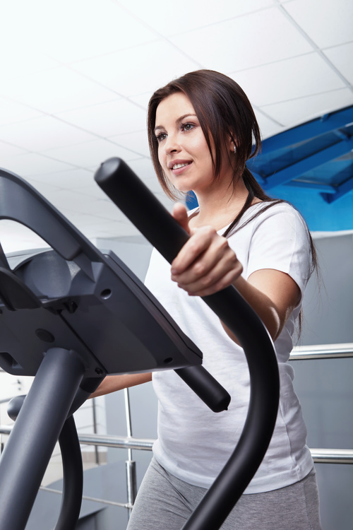 Woman doing exercise on treadmill Stock Photo