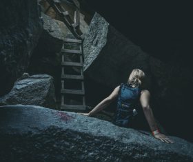 Woman exploring a grotto Stock Photo