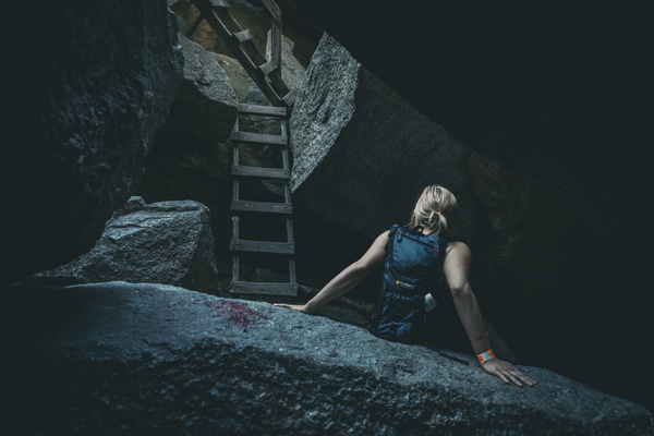 Woman exploring a grotto Stock Photo