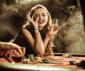 Woman holding bargaining chip in casino Stock Photo 02