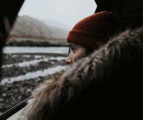 Woman looks out the car window Stock Photo