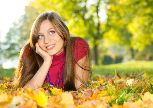 Woman lying on the ground looking into the distance Stock Photo
