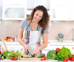 Woman making salad in the kitchen Stock Photo