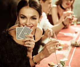 Woman playing cards in casino Stock Photo