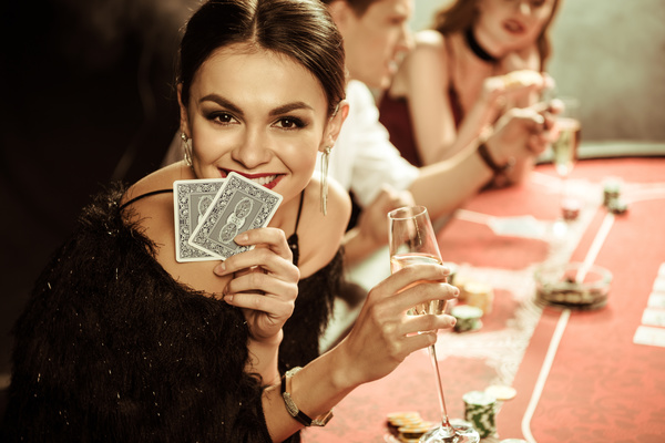 Woman playing cards in casino Stock Photo