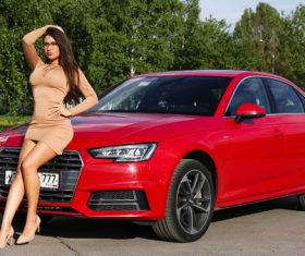Woman sitting posing in front of the car Stock Photo
