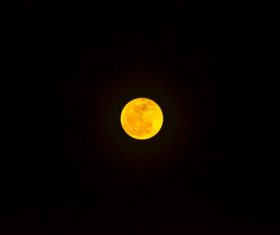Yellow round moon in dark sky Stock Photo