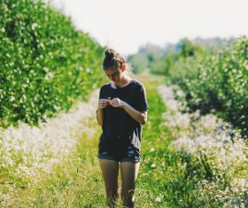 Young girl standing in the orchard Stock Photo