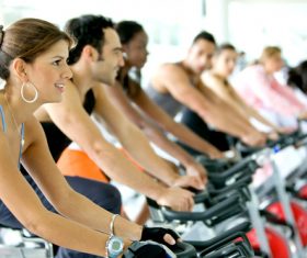 Young man doing aerobic exercise in gym Stock Photo