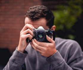 Young man having fun with camera Stock Photo