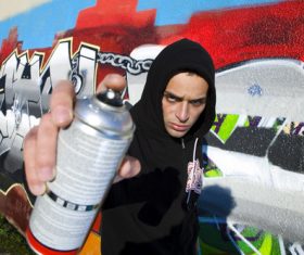 Young man holding a paint can Stock Photo